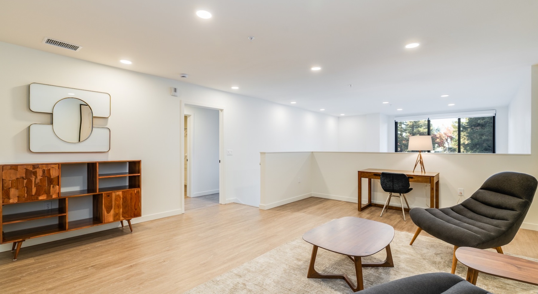 a spacious loft with chairs and wall art